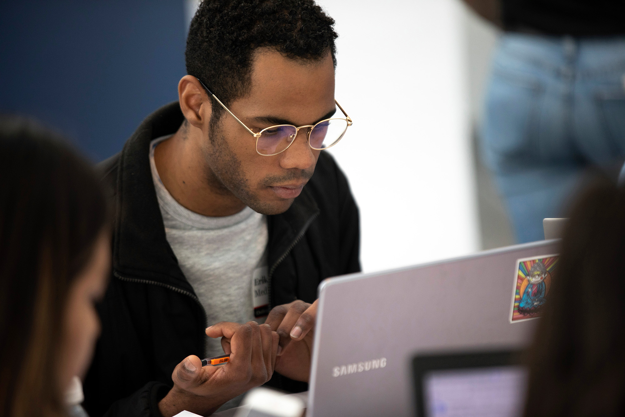 A student works on a laptop.
