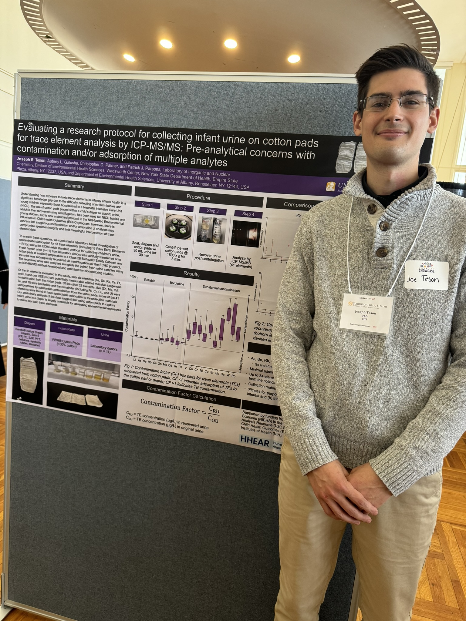 Joseph Teton in front of his poster at poster day