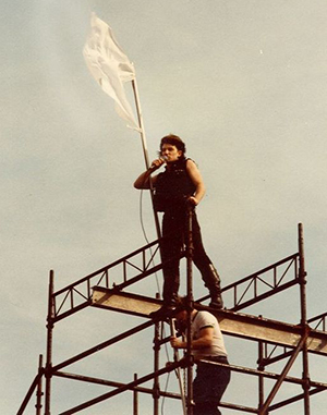 U2's impetuous lead singer Bono climbs up and sings upon the scaffolding.