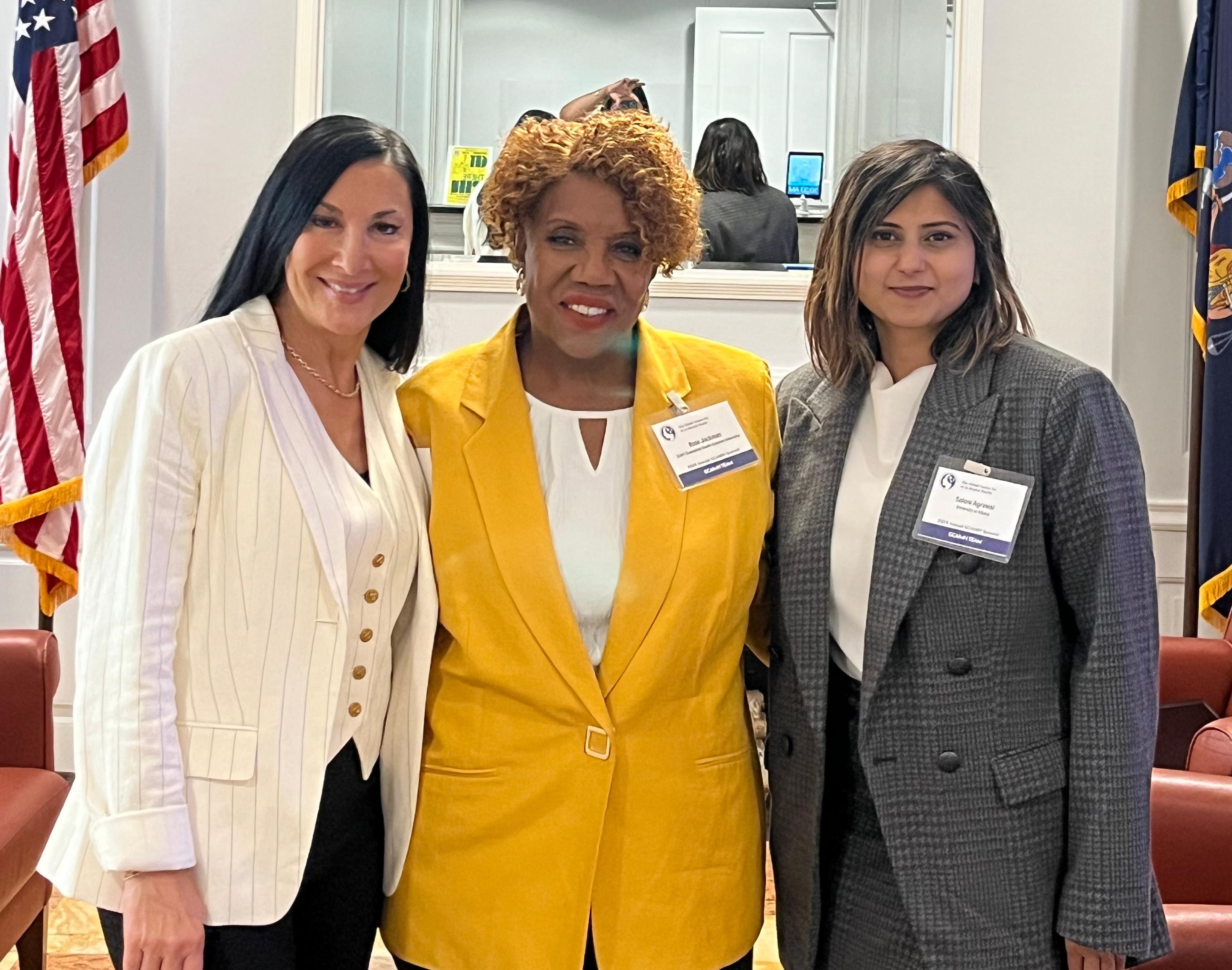 Three individuals at the 2025 GCAIMH event.