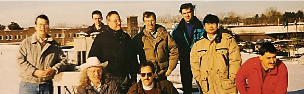 Maintaining deployed instruments – Researchers and staff on the roof of the ASRC when it was located at 100 Fuller Road! From back to front row (left to right): Robert Seals, Joe Michalsky, Mark Beauharnois, Bill Berkheiser III, James Schlemmer, Qilong Min. Front row kneeling; Jerry Berndt, Richard Perez and Lee Harrison, circa 1993.