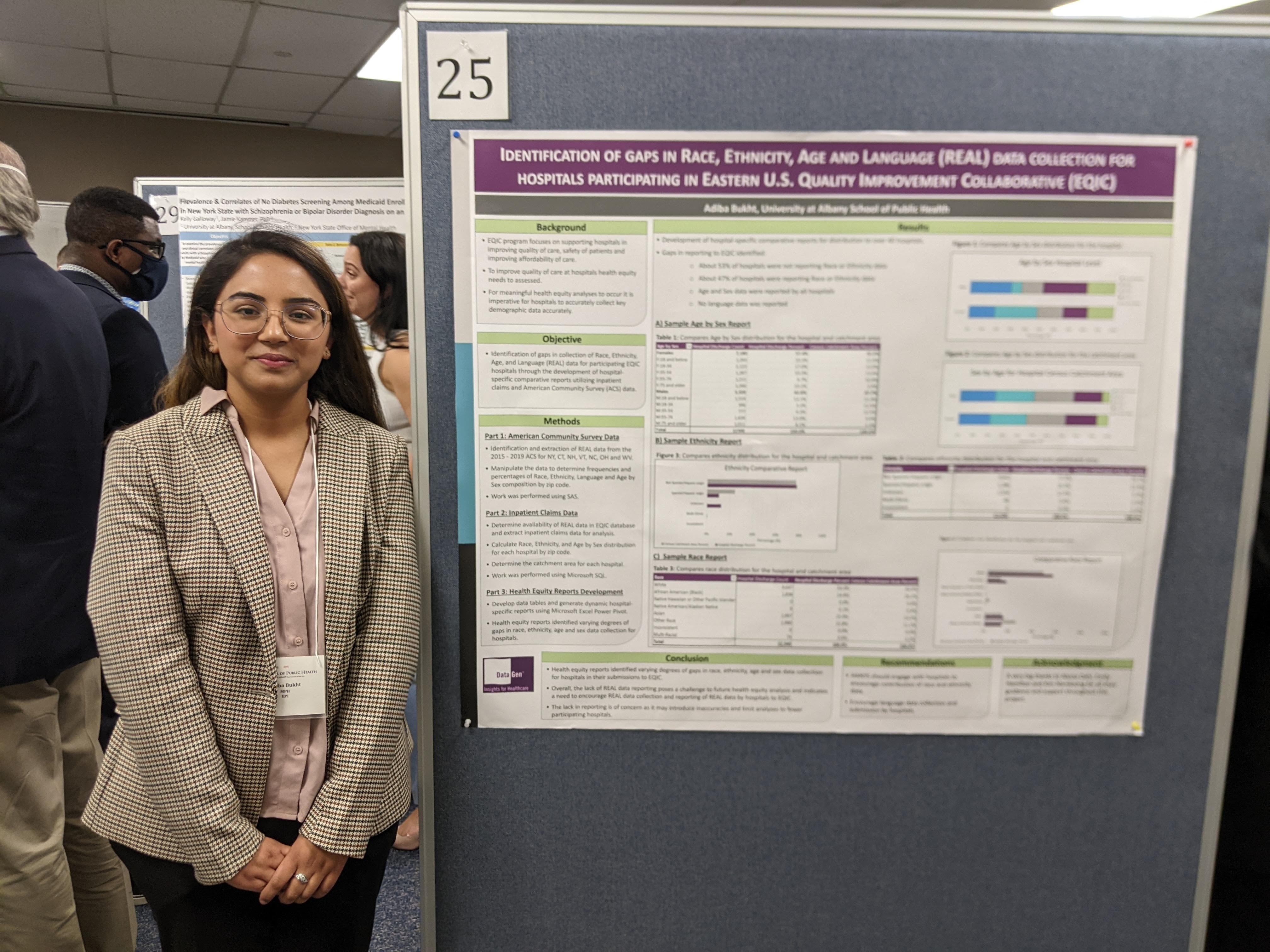 Adiba stands next to her poster on Poster Day