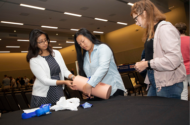 Students practice tourniquet techniques in “Stop the Bleed” training at the inaugural School Safety and Preparedness summit.