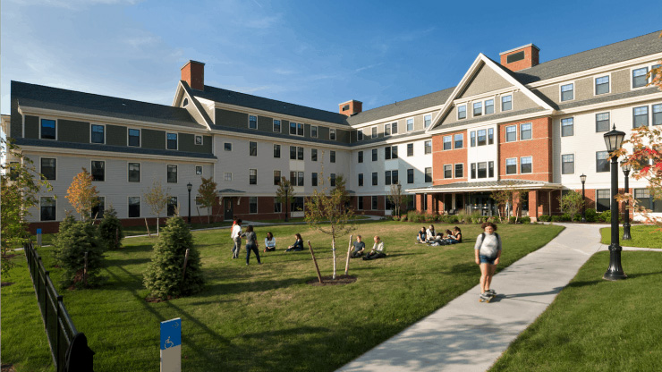 Residents enjoy a sunny day outside in the grounds of Unity Apartments.