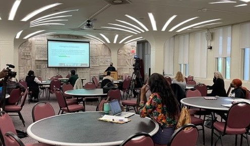 people at round tables watching a presentation at the Equity in Transition Summit