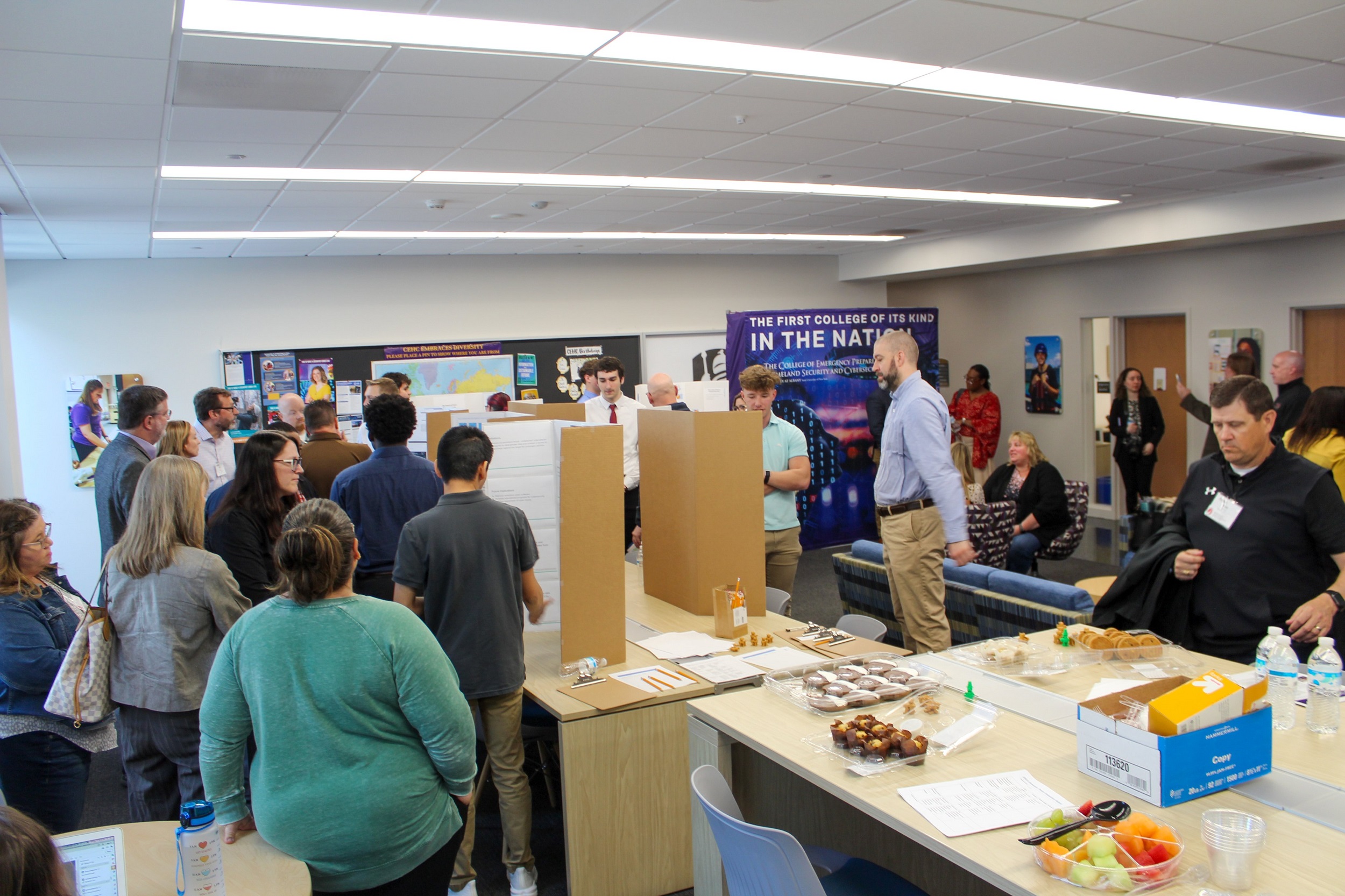 EPICH students share poster presentations with attendees at the showcase event.