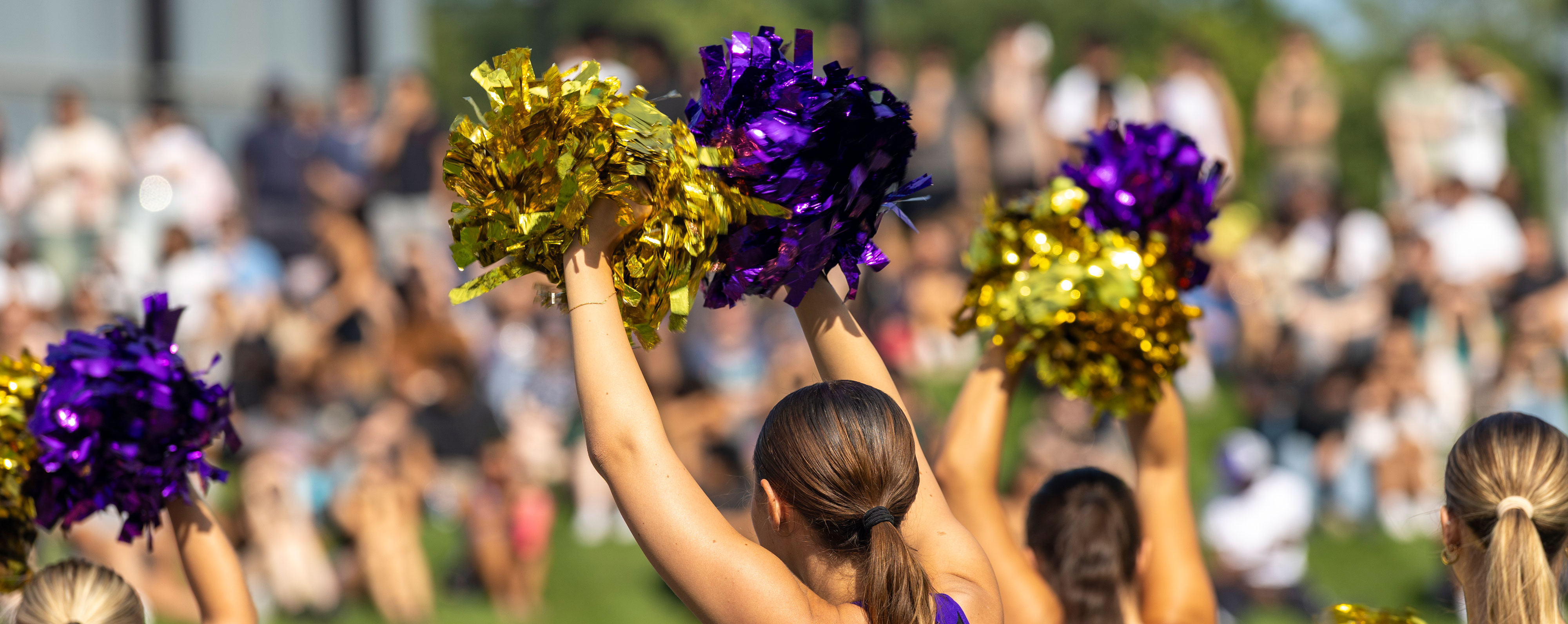 UAlbany cheer leaders raise their pom poms during a Welcome Week event at UAlbany.