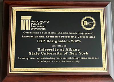 A picture of a plaque designating UAlbany an IEP University