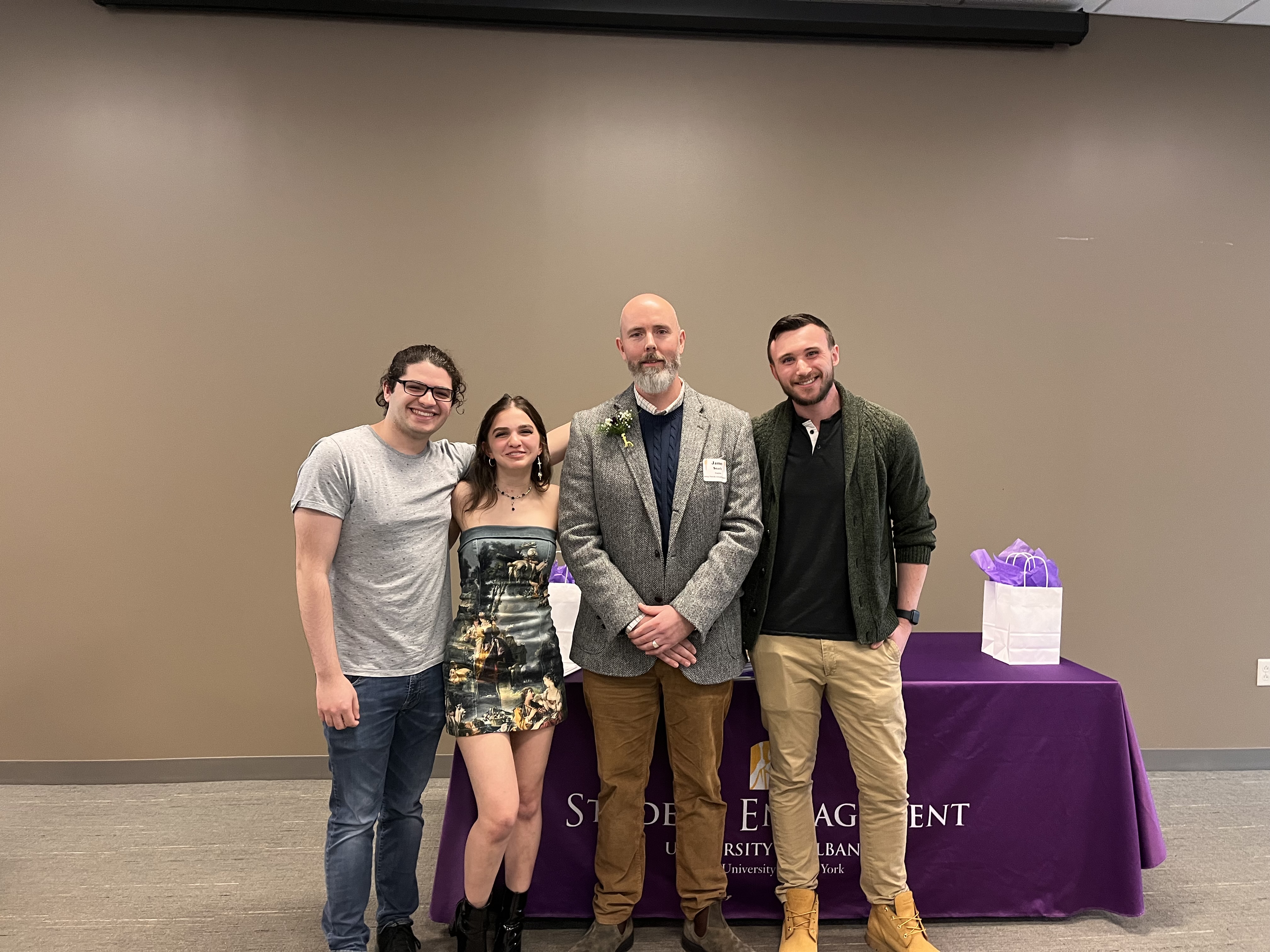 UAlbany students stand with lecturer James Searle at the Torch Awards ceremony.