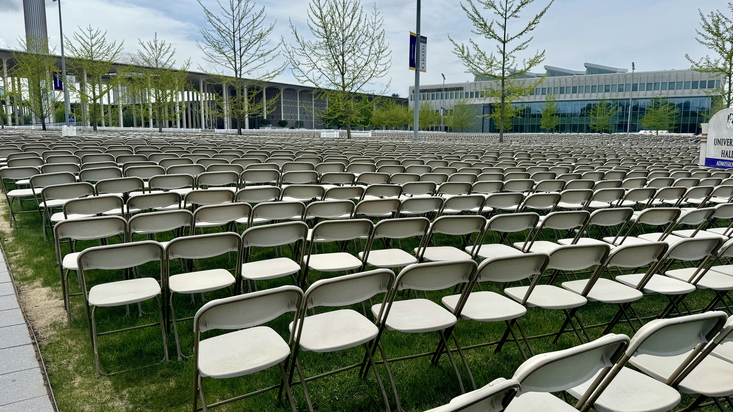 Rows of chairs are lined up in the entry plaza of the Uptown Campus for the 2024 undergraduate commencement ceremony.