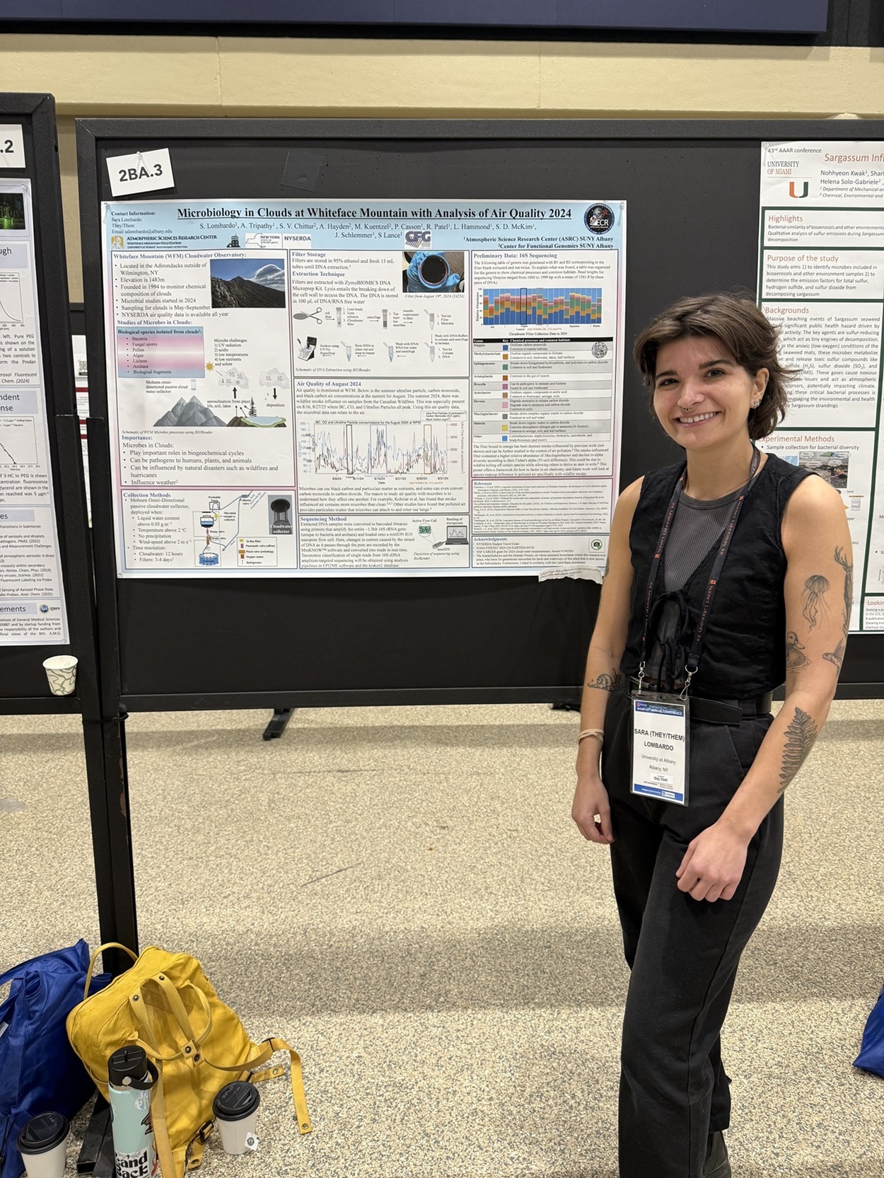 Sara Lombardo stands in front of their poster presentation at the American Association for Aerosol Research conference.