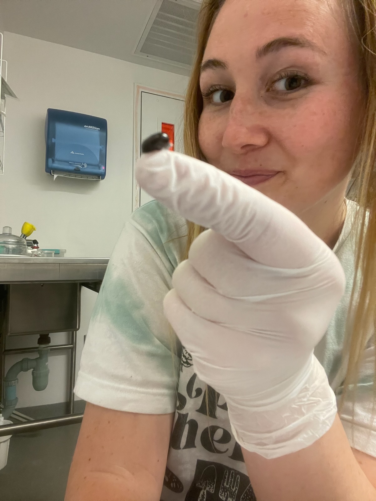 Rachel Lange holds up a specimen in the lab.