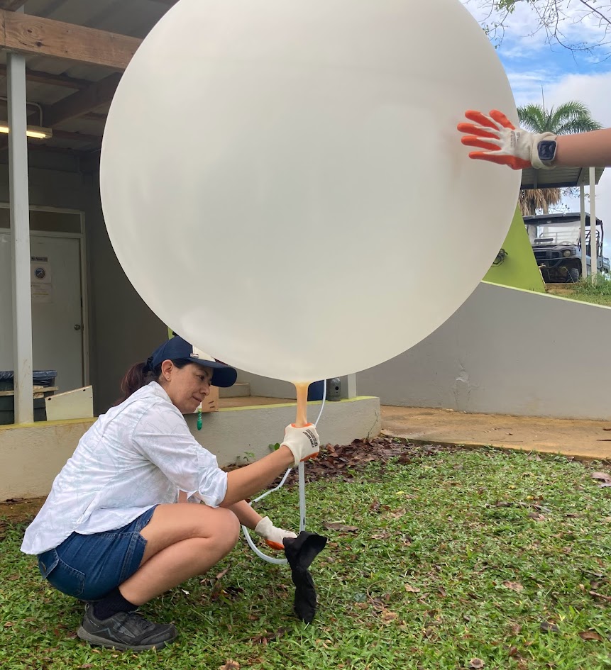 UAlbany student Bernadette Leyba prepares a weather balloon for launch.