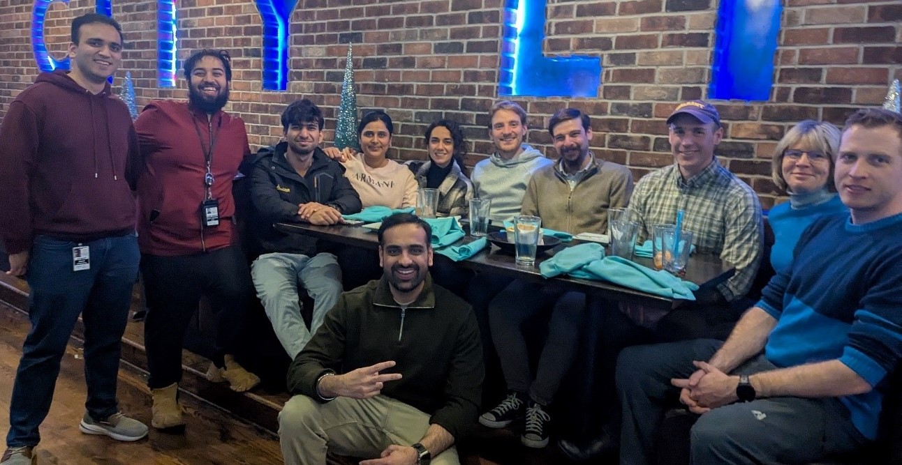 UAlbany's Cady Research Lab group photo with eleven individuals sitting around a table.