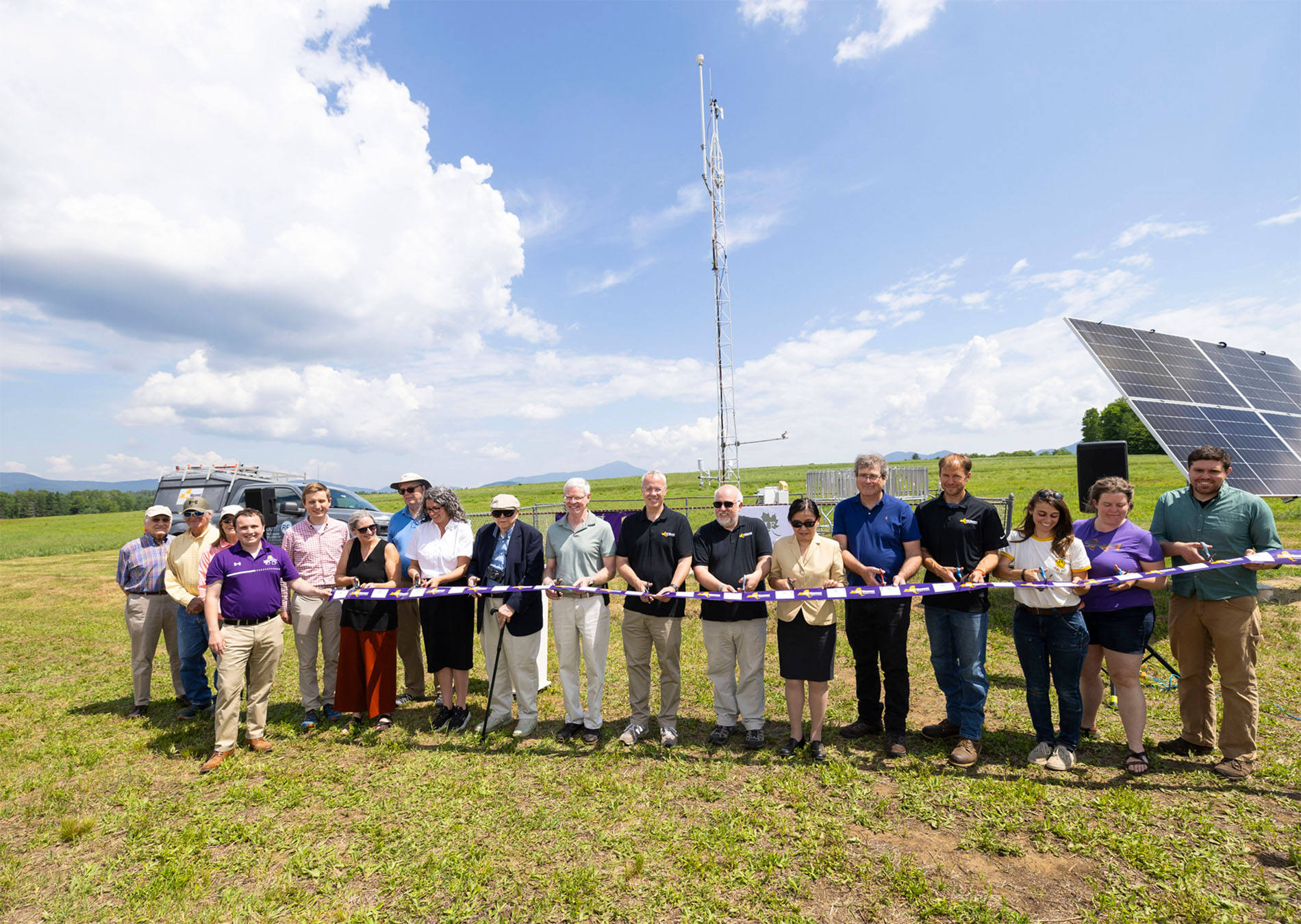 UAlbany and Uihlein Foundation community members cut a purple ribbon to celebrate the opening of the Mesonet's Lake Placid site. 