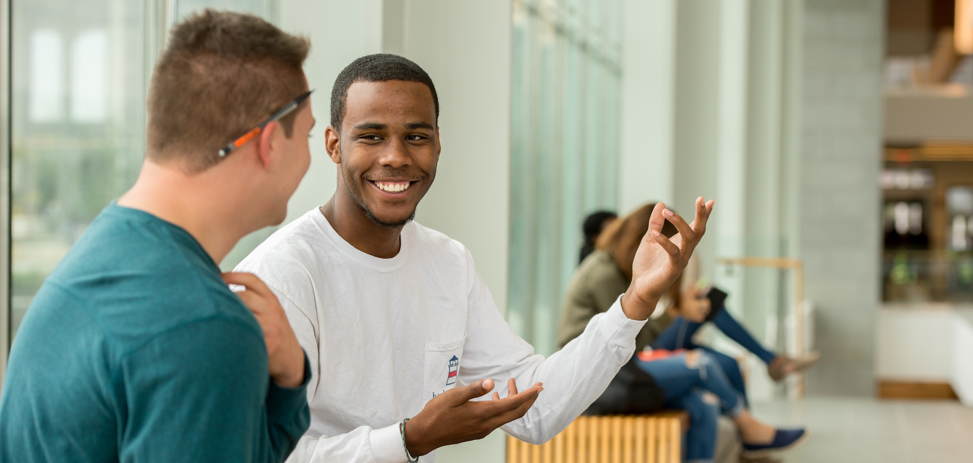 Two students study together while sitting on a bench