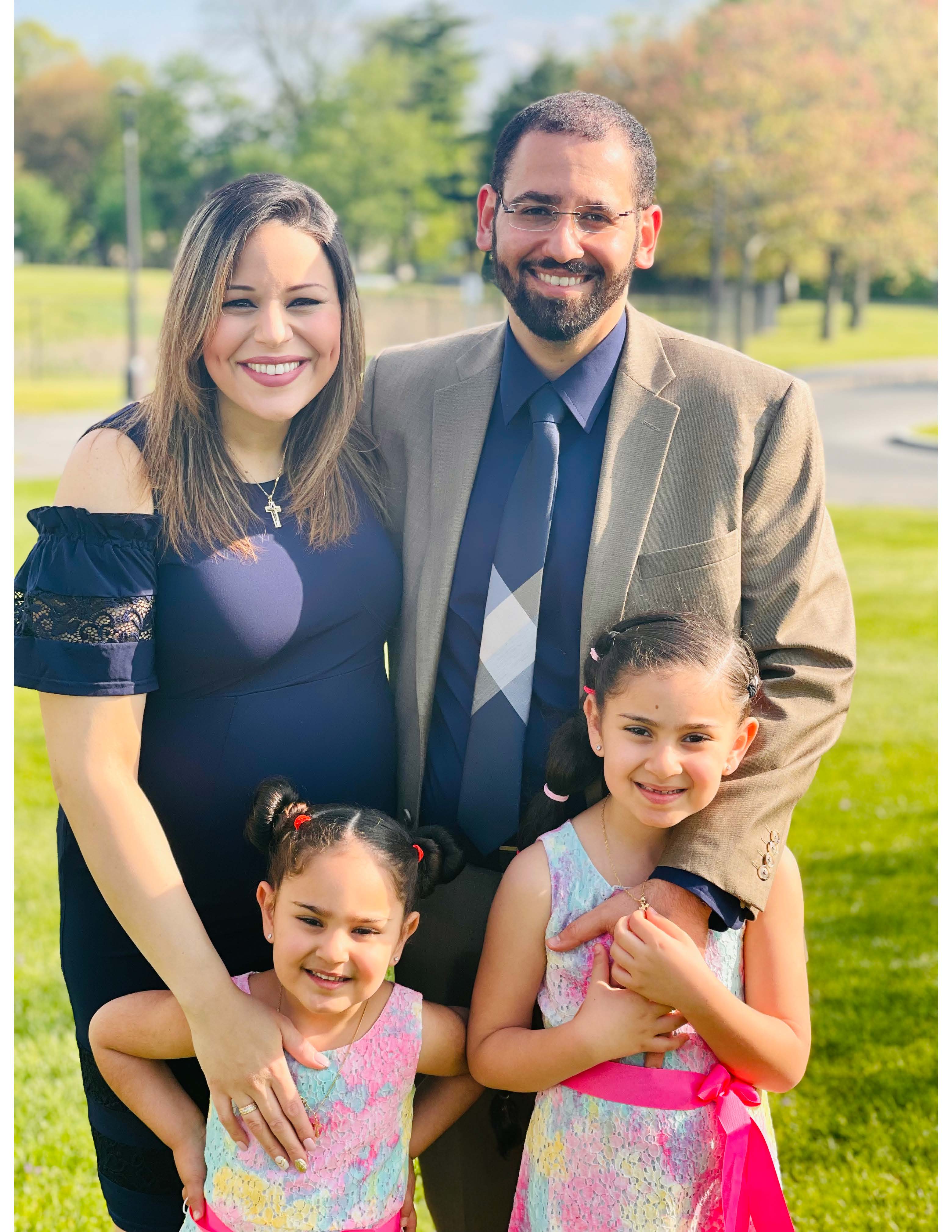 Mena and Mirna Hanna smile at the camera, along with their two daughters.