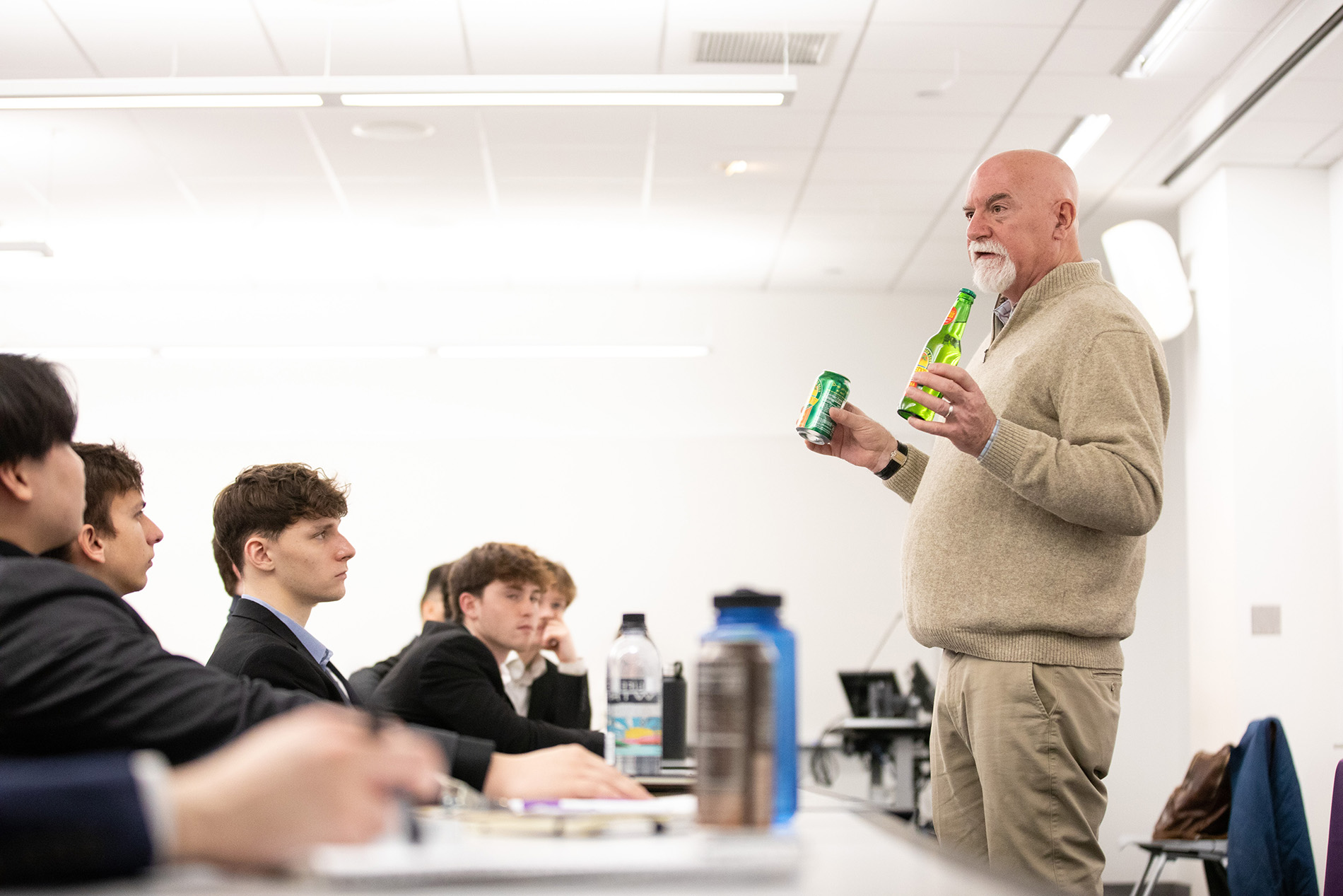 Norm Snyder talking to students and holding Reed's products