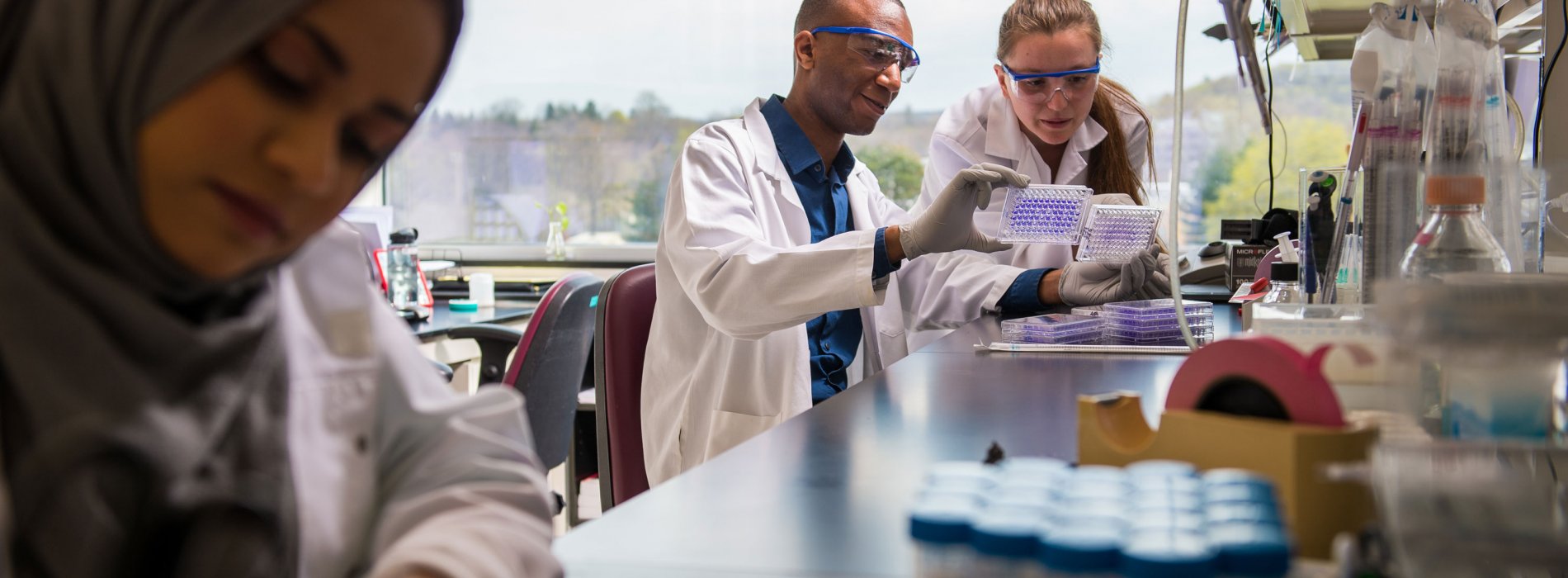 Students Looking at lab equipment in Cancer Research Center