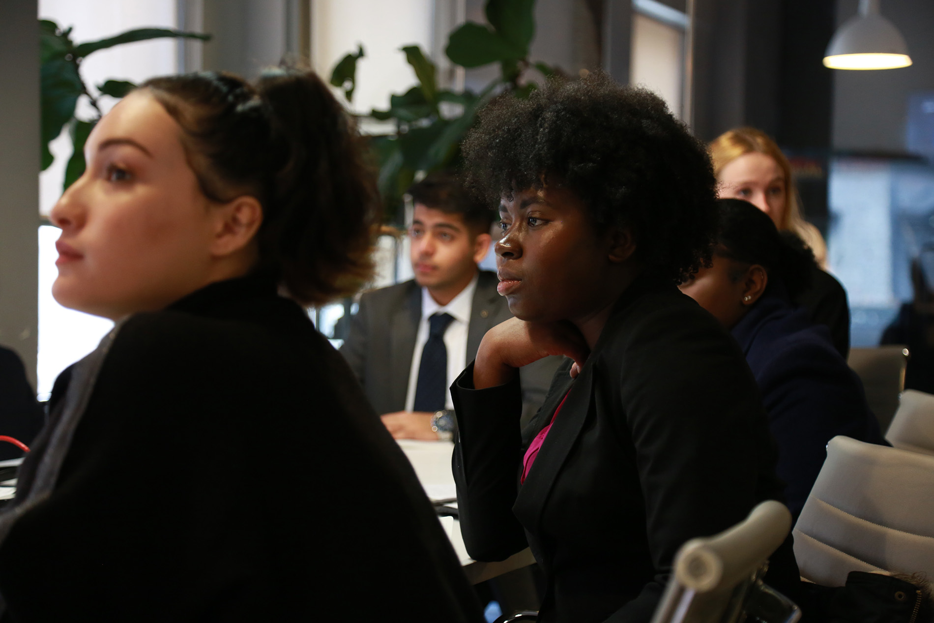 Students listening to speaker at meeting 