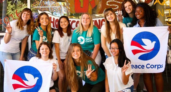 Students hold Peace Corps banners.