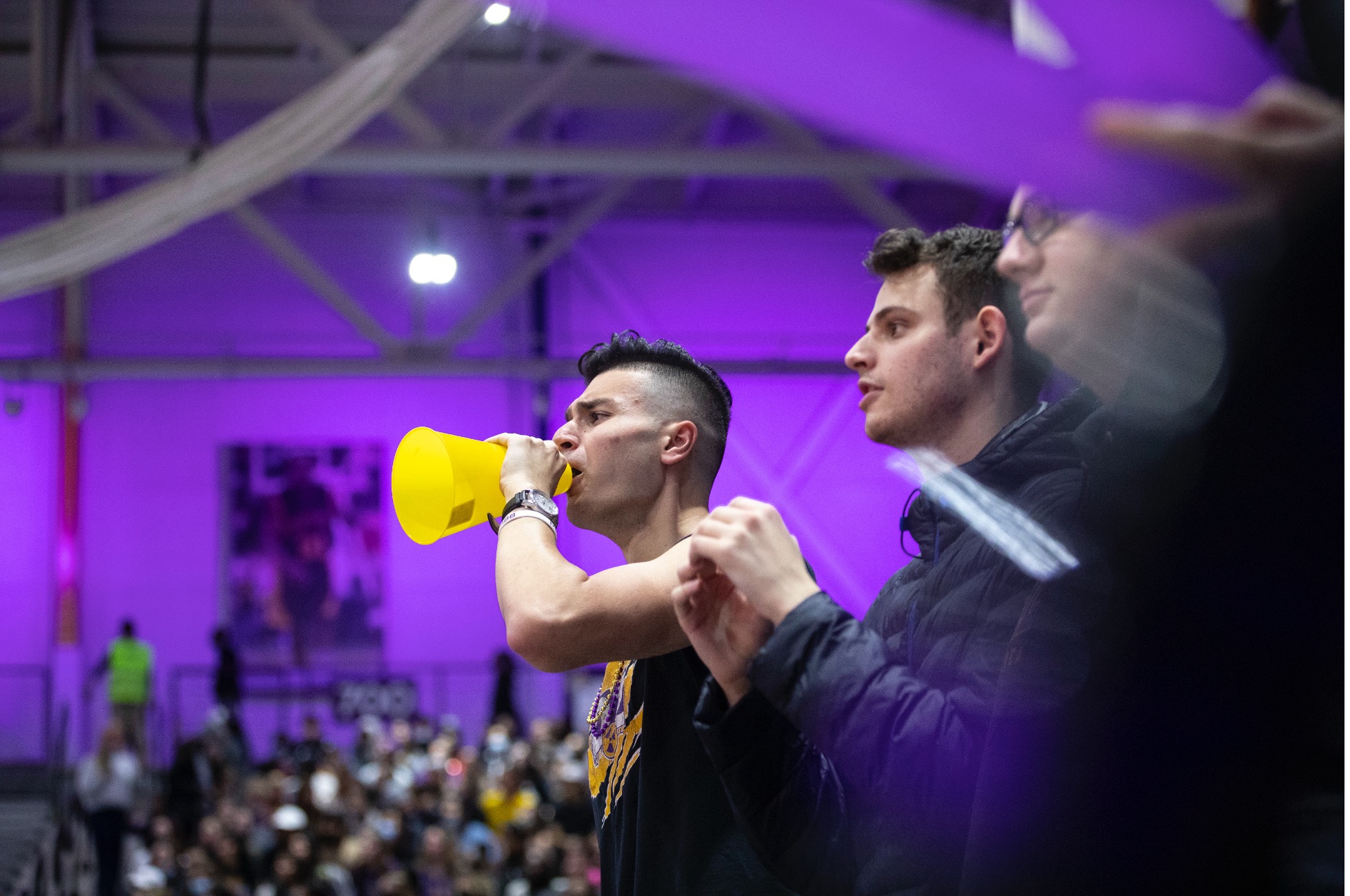 Students at a sports event cheer on the UAlbany team.