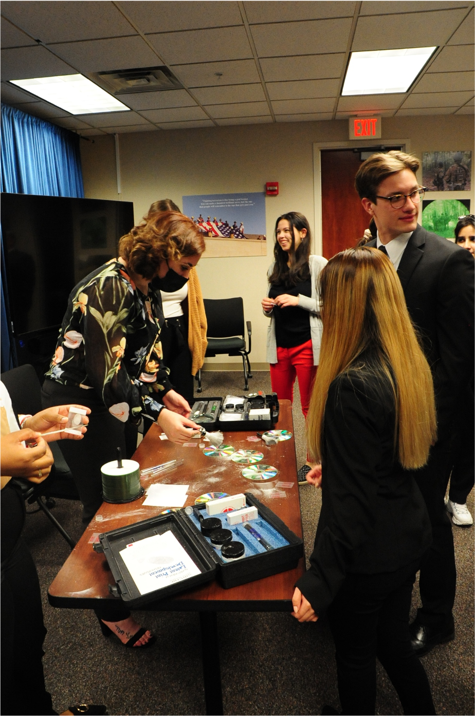 Students receive a hands-on demonstration of fingerprinting tools used at a crime scene.