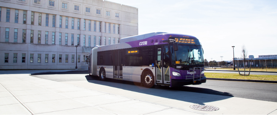 A UAlbany bus waits for passengers at a bus stop.