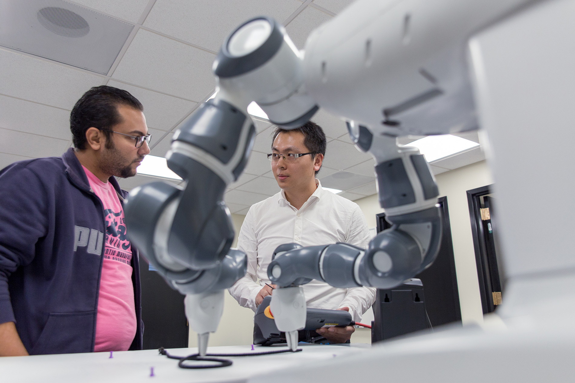 ece professor and student conducting robotics research in lab