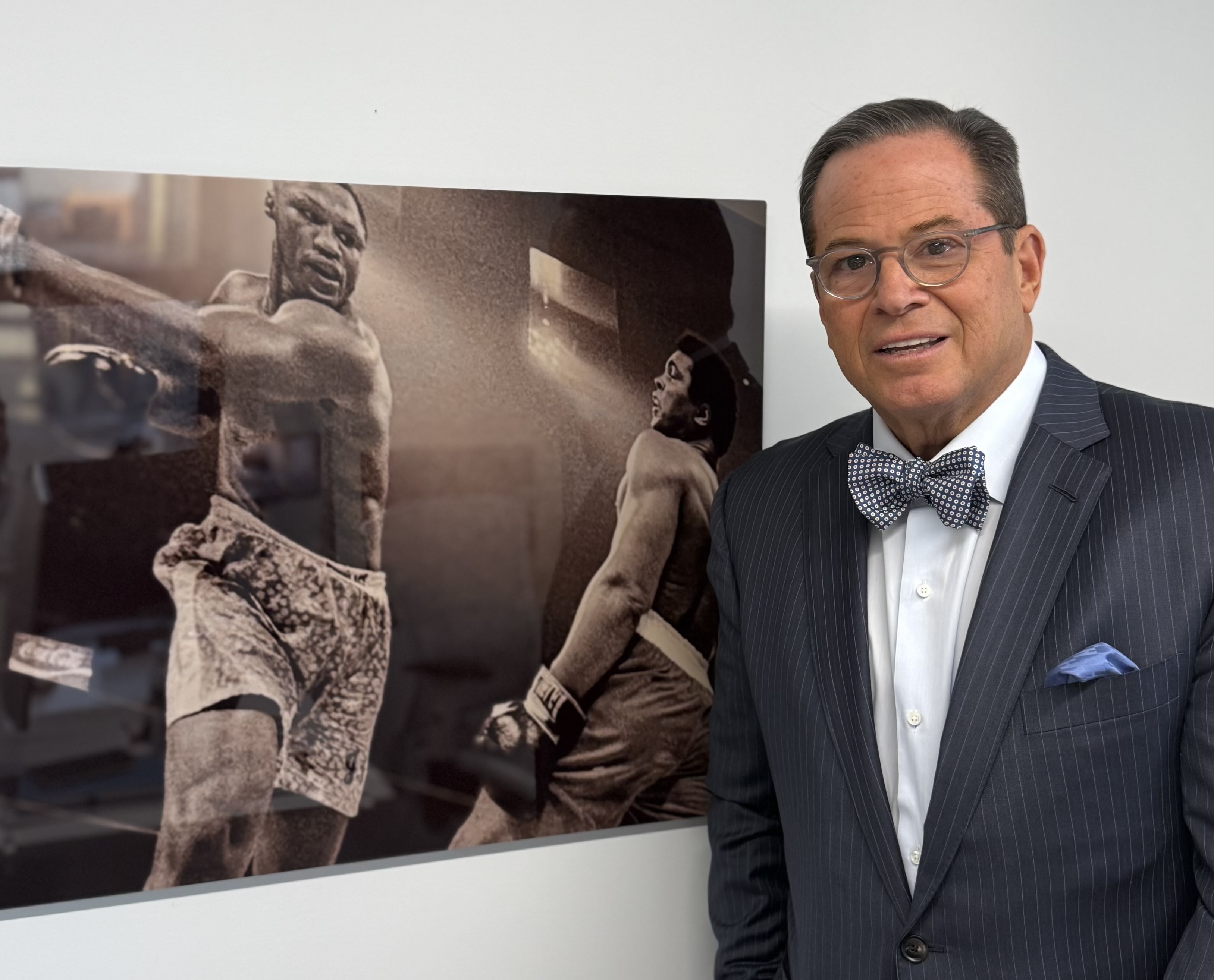 Steven Nigro with a photo of Muhammad Ali
