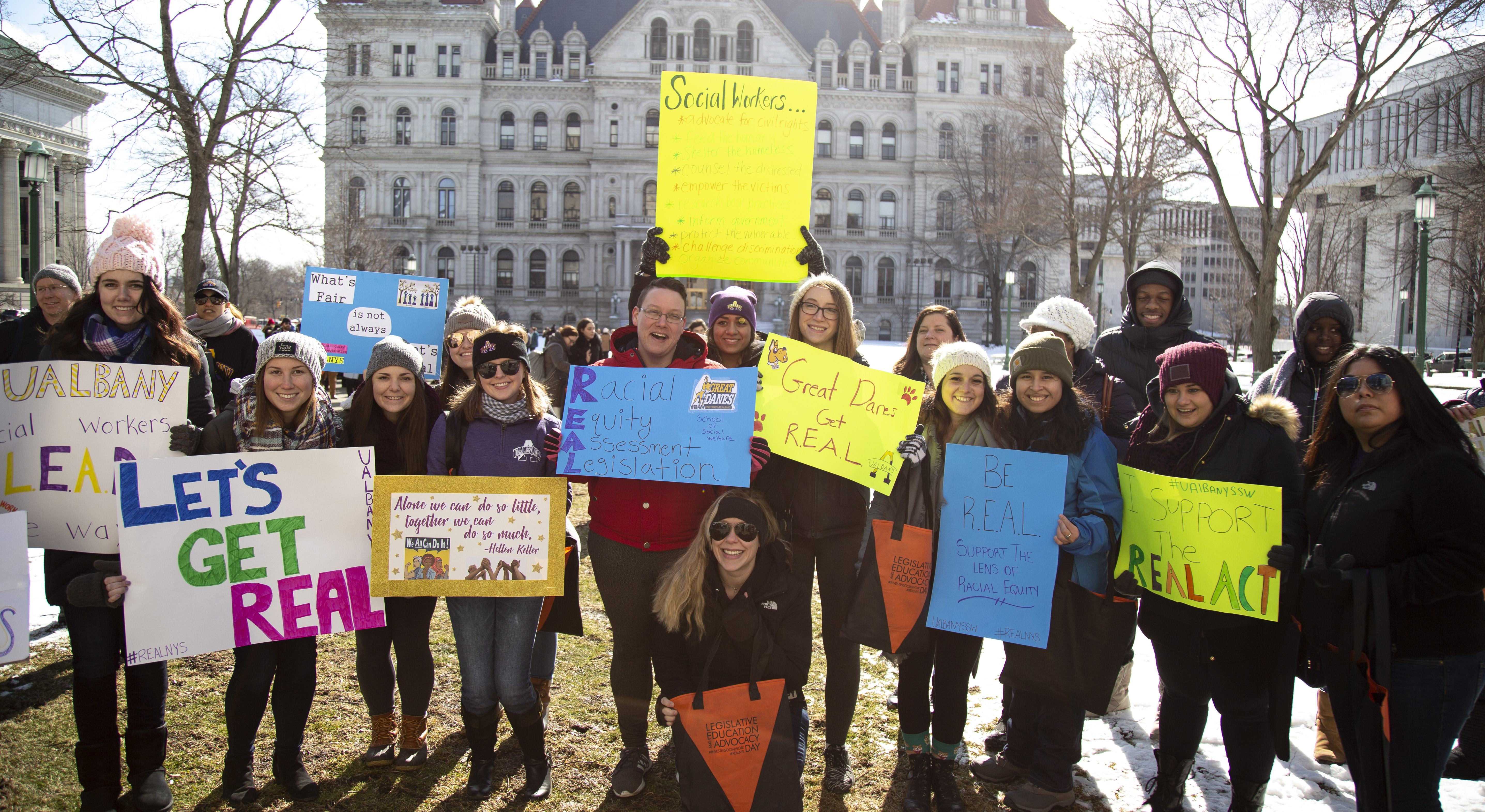 SSW students holding advocacy posters while attending LEAD Day at the New York State Capitol