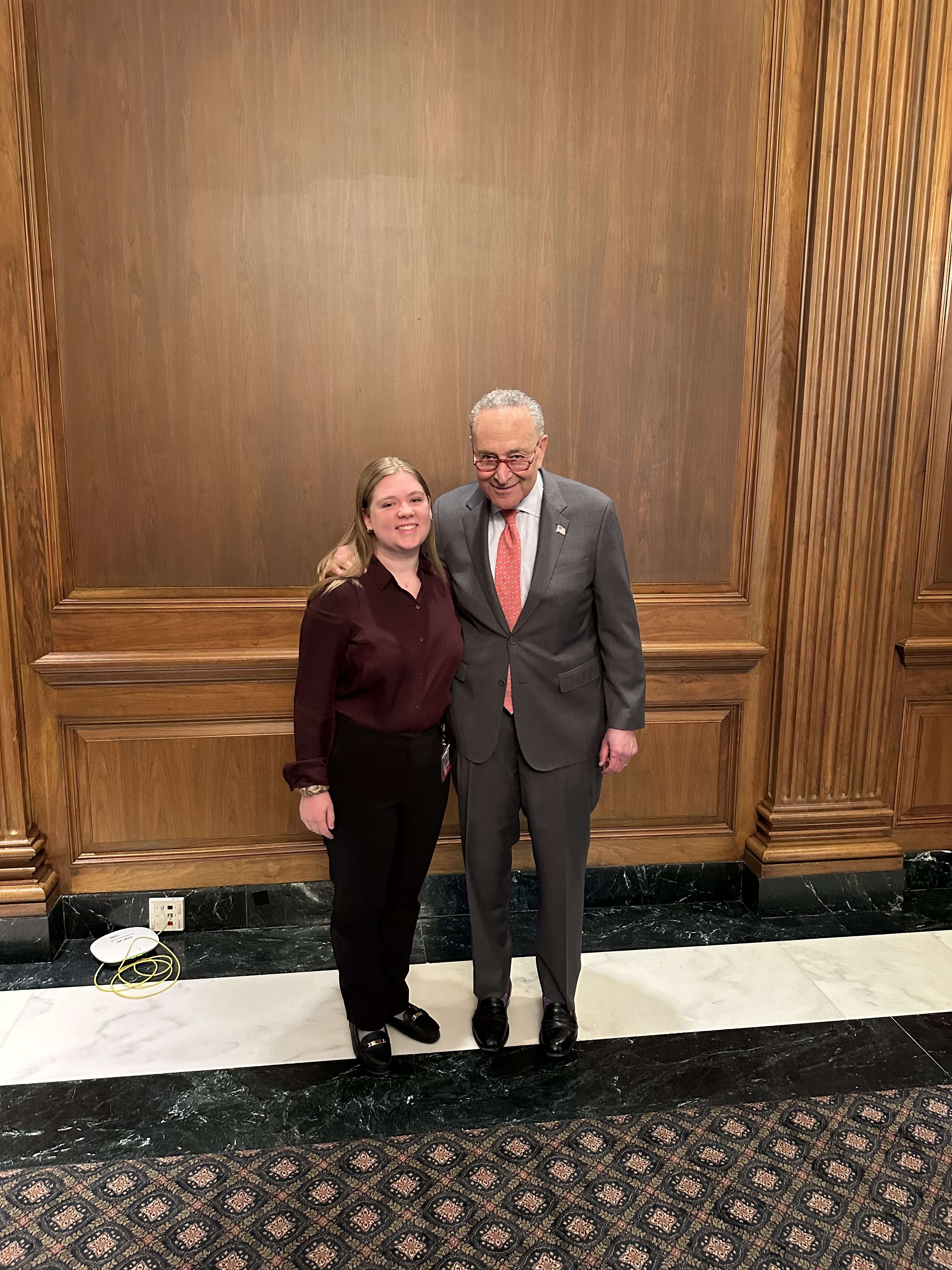 UAlbany student Kayla Cooper stands with Senator Chuck Schumer.
