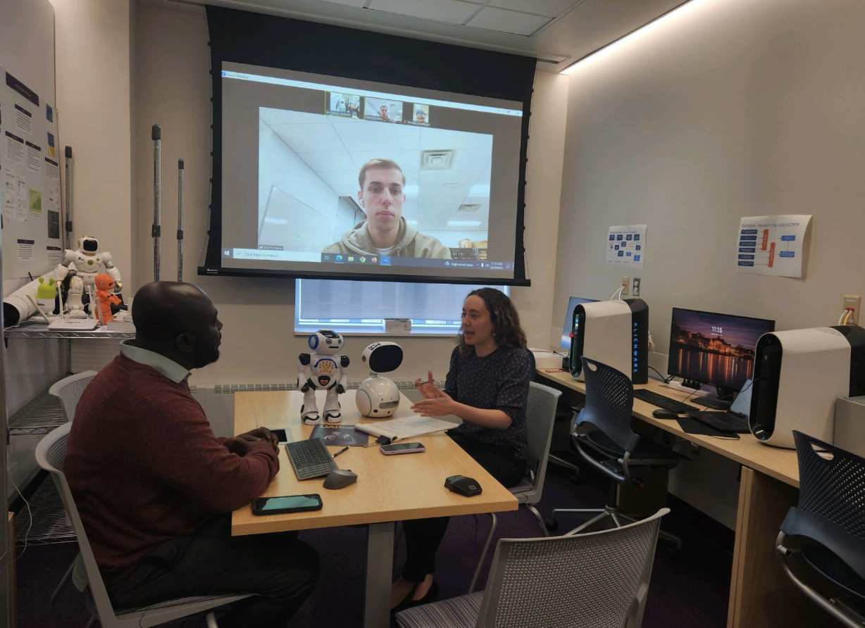 Fiona Hernandez speaking with Dr. Benjamin Yankson and his students