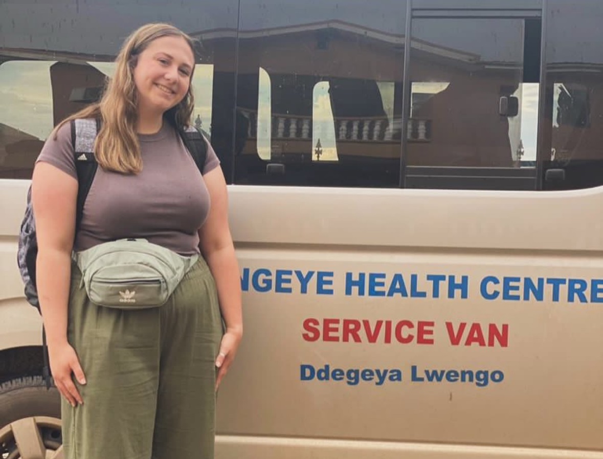 Sophie Whiteman stands in front of service van at the Engeye Health Clinic in in Uganda.