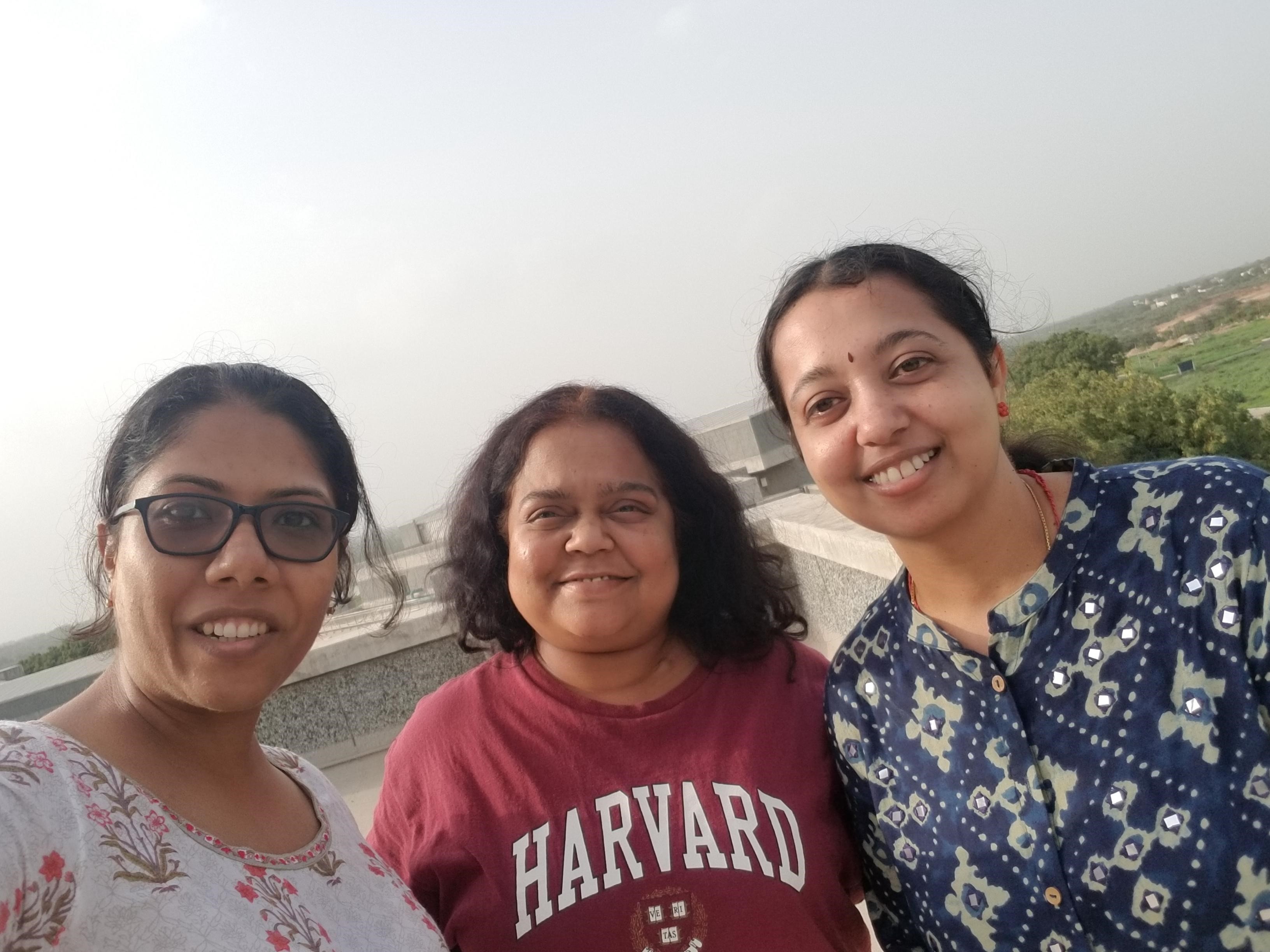 A selfie of three women outside.