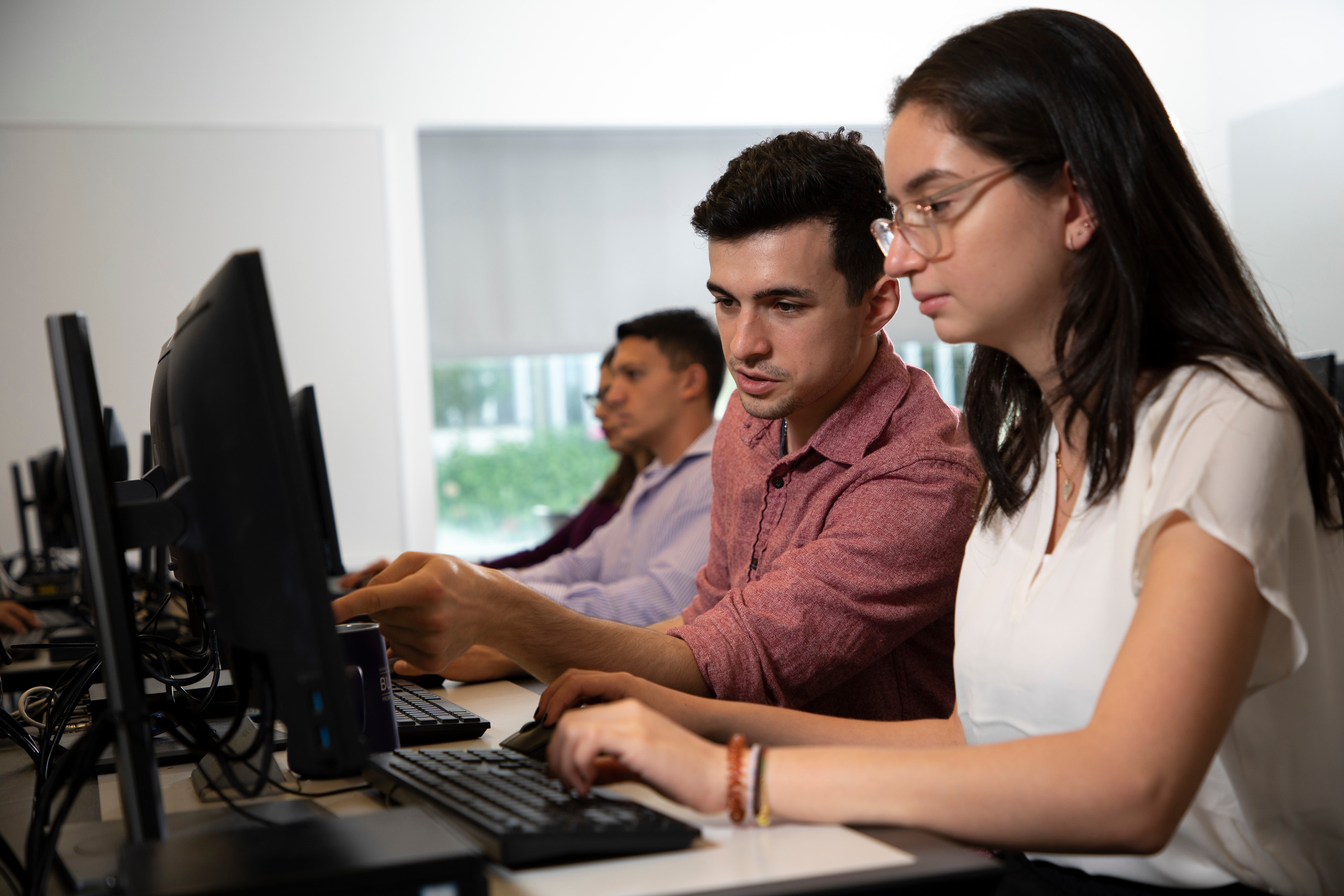 Students collaborating on cyber research project