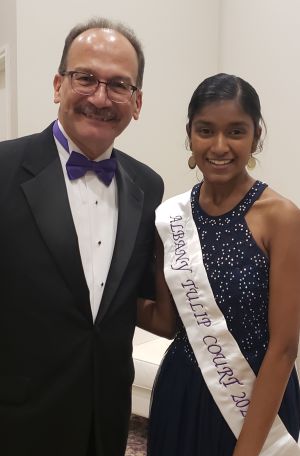 President Rodríguez, in a tux and purple bow ties, poses with Sakthi Muthukrishnan , wearing a Albany Tulip Court sash 
