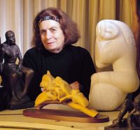 Terri Boor sits surrounded by sculptures