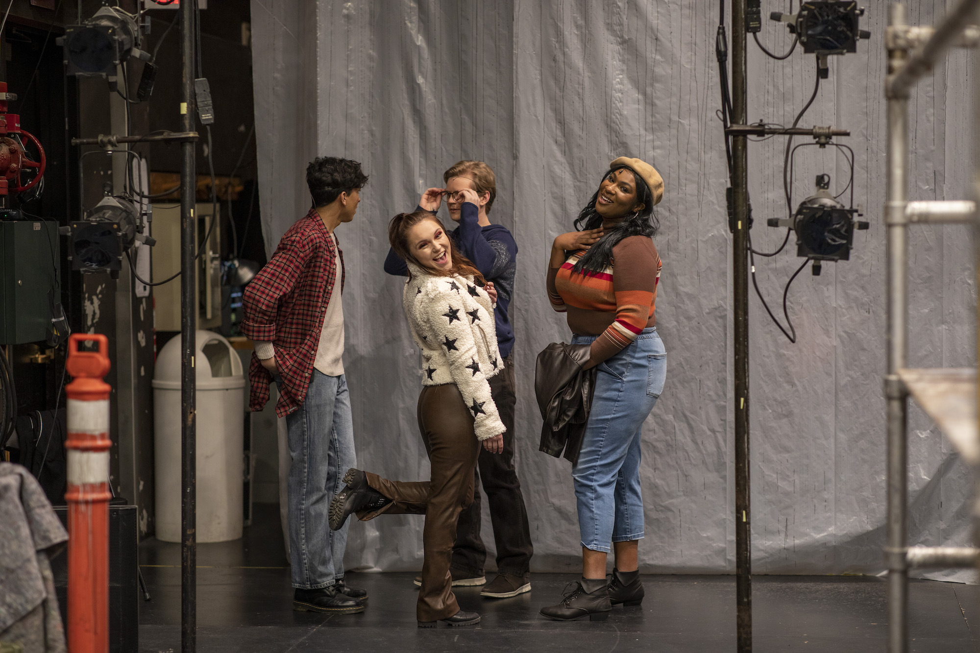 The student cast of "Rent" poses for a picture backstage at dress rehearsals.
