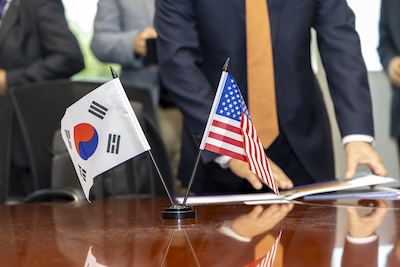 South Korean and American flags next to each other on a table