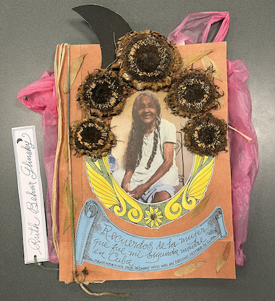A handmade book is decorated with dried sunflowers