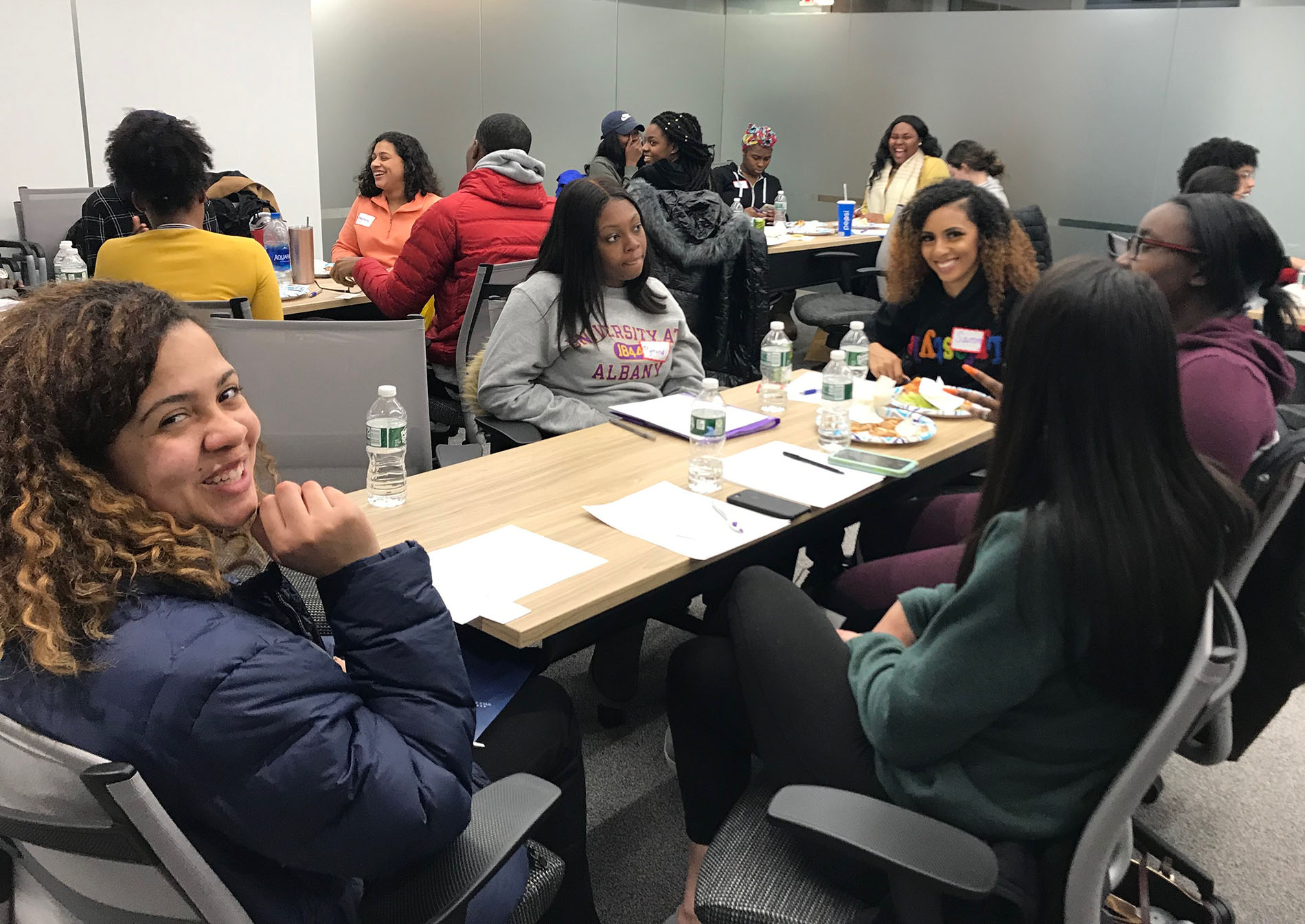 students sitting around tables talking