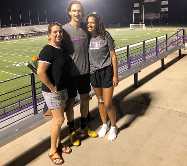 Kaio DaSilva stands with his mother and sister at Tom & Mary Casey Stadium.