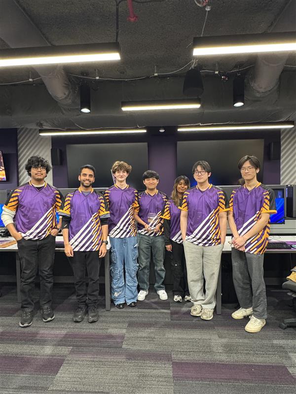 The UAlbany Esports Valorant team stands together for a photo in their jerseys.