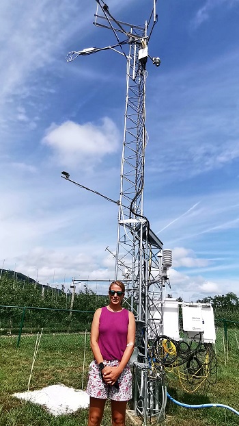 Perno stands in front of the weather station at the NYS Mesonet site at Indian Ladder Farms in Voorheesville.