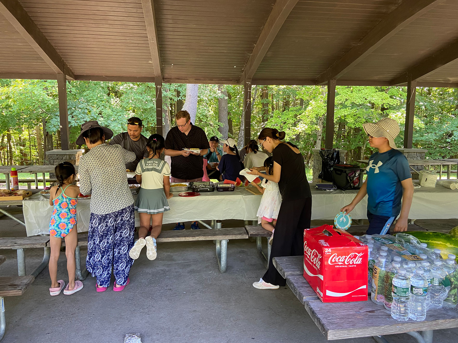 The UAlbany Asian Coalition of Professionals guests serving themselves at picnic table