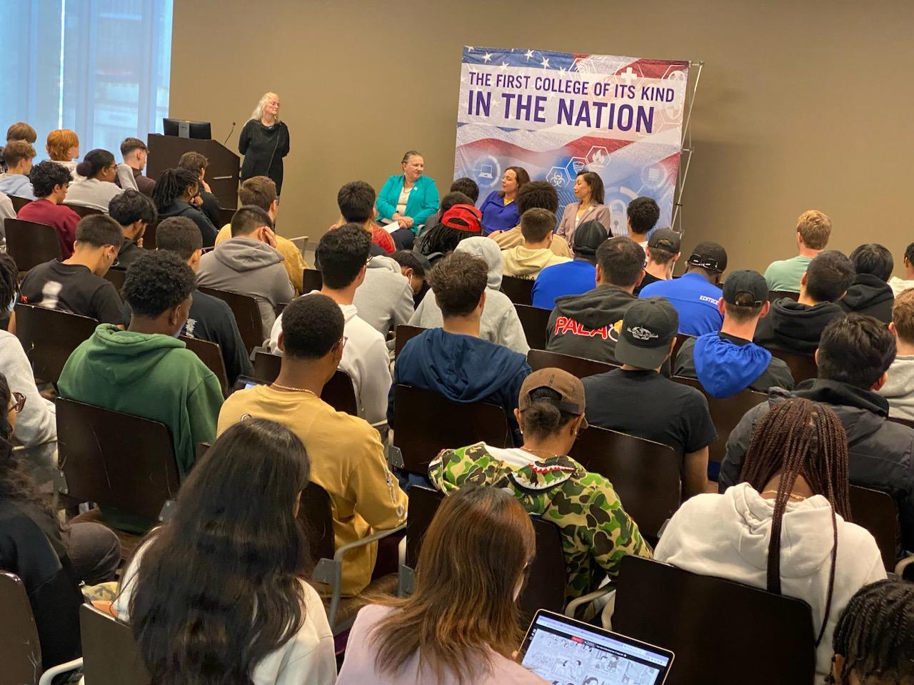 Women in leadership panel with full crowd at Campus Center