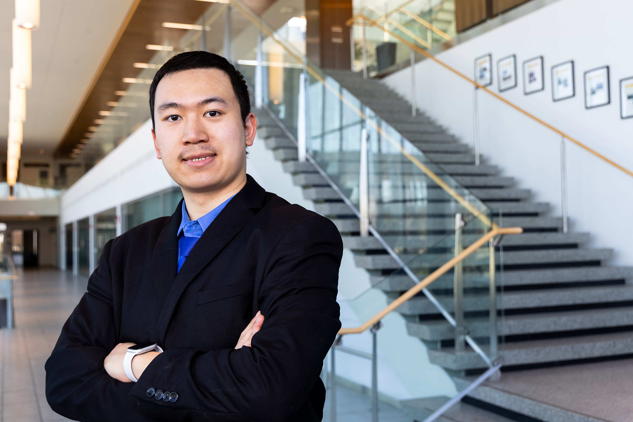 A portrait of UAlbany student Addison Yang inside of the Massry School of Business building