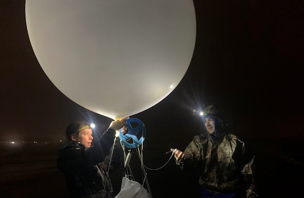 UAlbany undergraduate students preparing a weather balloon to collect data during the 2022 WINTRE-MIX field campaign.