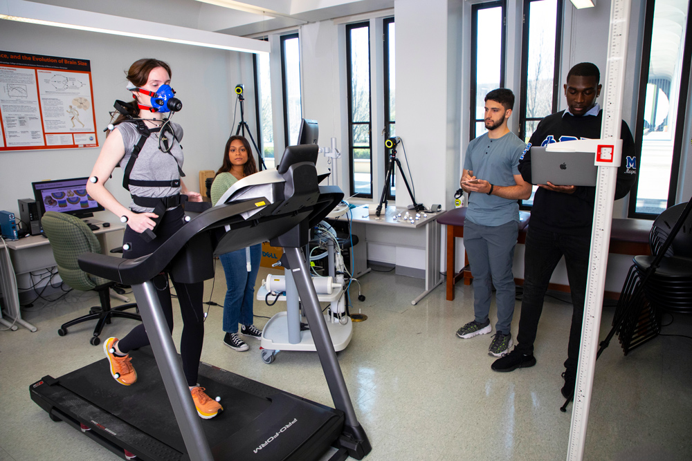 Student researchers gathering data from a runner in a UAlbany biomechanics lab.